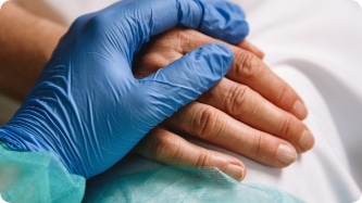a successful nursing recruiter holding a patient's hand